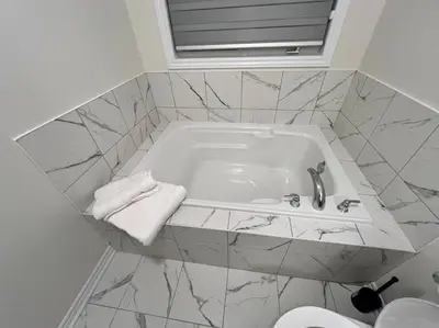 a bathroom with a bath tub with a sink at Niagara's entertainment house in Thorold