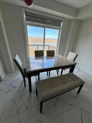 a dining room with a table and chairs and a window at Niagara's entertainment house in Thorold