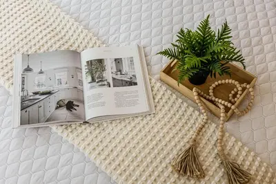a book sitting on a table with a potted plant at The Snug 1plus1 Suite with Free Parking in Toronto