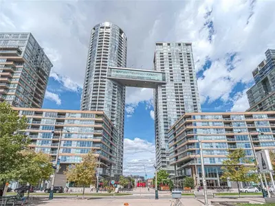 two tall buildings with a sign in front of them at The Snug 1plus1 Suite with Free Parking in Toronto