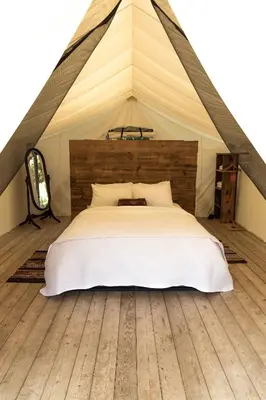 a bedroom with a bed in a tent at Homegrown Hideaway in Port Dover
