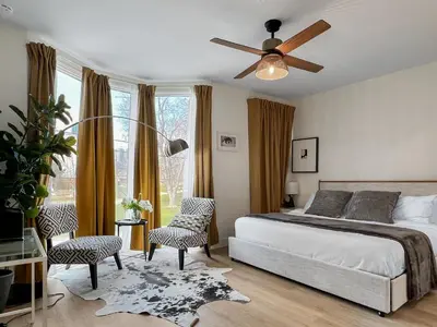 a bedroom with a bed and a ceiling fan at Elegant 2 Bedroom with Parking in Toronto