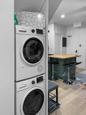 two washing machines stacked on top of each other in a kitchen at Elegant 2 Bedroom with Parking in Toronto