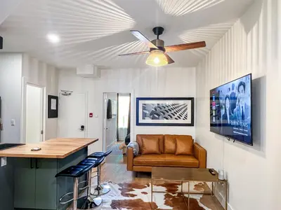 a living room with a ceiling fan and a couch at Elegant 2 Bedroom with Parking in Toronto