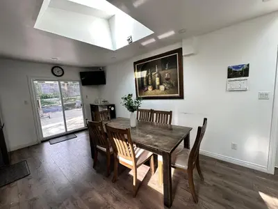 a dining room with a wooden table and chairs at Riverwood Home in Mississauga