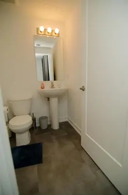 a bathroom with a toilet and a sink at Niagara Escape Crib: 3km from NiagaraFalls in Niagara Falls