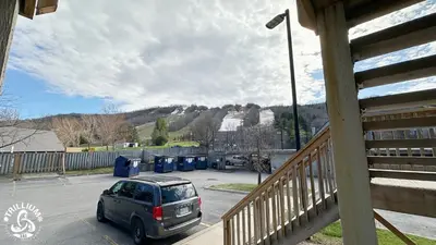 a car parked in a parking lot next to a fence at Blue Mtn 1 Bedroom with Mountain View in Blue Mountains