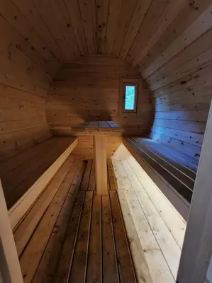 an inside of a wooden sauna with a window at Red Cedar Chalet on Brady Lake in Hindon Hill
