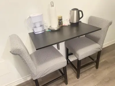 a black table with two chairs and a blender on it at Keppel Circle Residence in Brampton