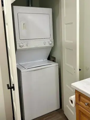 a microwave on top of a refrigerator in a kitchen at Beautiful tranquil centrally located condo in Collingwood