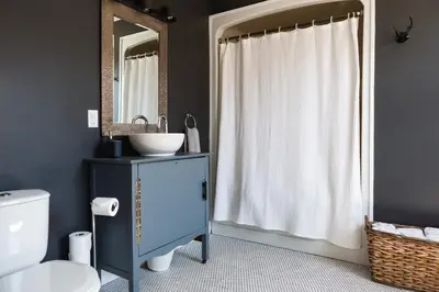 a bathroom with a sink and a toilet and a mirror at Woodland Chase in Wellington