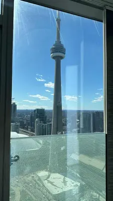 a view of the tower from the window of a building at DOWNTOWN, LUXURY CONDO, CN TOWER, ROGERS CENTER, SCOCIA ARENA, UNOBSTRUCTED VIEW in Toronto
