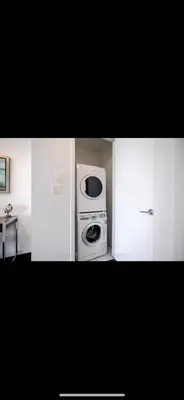 a kitchen with white cabinets with a microwave and a stove at DOWNTOWN, LUXURY CONDO, CN TOWER, ROGERS CENTER, SCOCIA ARENA, UNOBSTRUCTED VIEW in Toronto