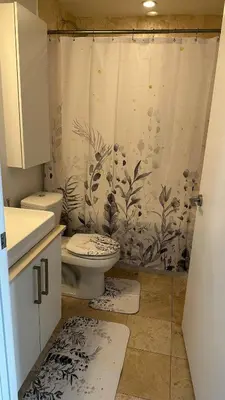 a bathroom with a toilet and a shower curtain at DOWNTOWN, LUXURY CONDO, CN TOWER, ROGERS CENTER, SCOCIA ARENA, UNOBSTRUCTED VIEW in Toronto