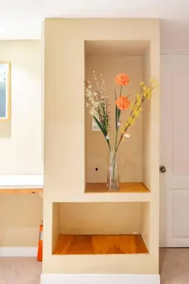 a vase of flowers sitting on a shelf in a room at Cozy basement apartment in Newmarket in Newmarket