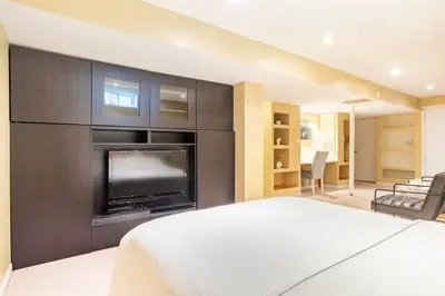 a bedroom with a large bed and a fireplace at Cozy basement apartment in Newmarket in Newmarket