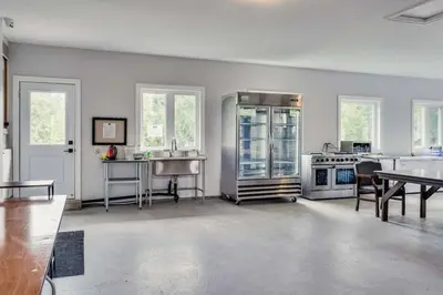a large white kitchen with stainless steel appliances at Large Estate with Luxury Collection of Amenities in Schomberg