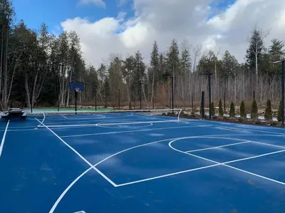 a blue tennis court with a net on it at Large Estate with Luxury Collection of Amenities in Schomberg