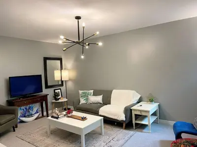 a living room with a couch and a tv at Superb Spacious Loft Old Toronto near Distillery District in Toronto