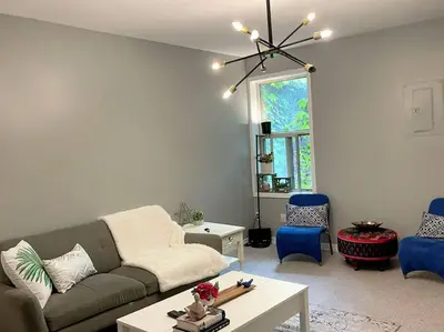 a living room with a couch and blue chairs at Superb Spacious Loft Old Toronto near Distillery District in Toronto