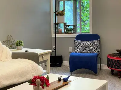 a bedroom with a bed and a desk and a blue chair at Superb Spacious Loft Old Toronto near Distillery District in Toronto