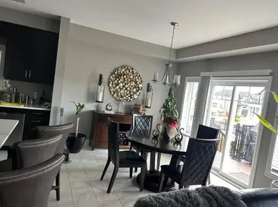 a kitchen and dining room with a table and chairs at Stunning House 4 bed 2.5 bath in Kitchener