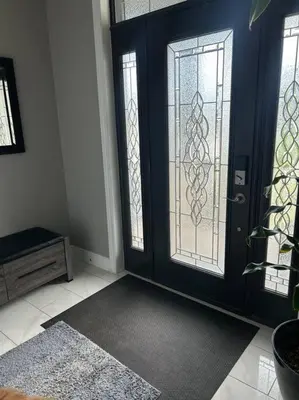 a room with a black door and two windows at Stunning House 4 bed 2.5 bath in Kitchener