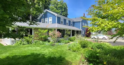 a blue house with a lawn in front of it at The Royal Manor Inn in Niagara on the Lake
