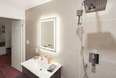 a bathroom with a shower and a sink at The Royal Manor Inn in Niagara on the Lake