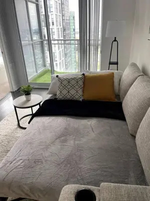 a large bed in a room with a large window at SkyHigh Haven LED-Lit Downtown Condo Retreat in Toronto