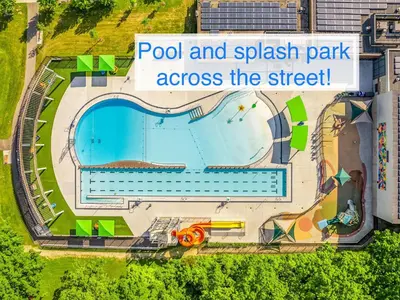 a sign that reads pool and splash park across the street at Luxury Family Home in Burlington in Burlington
