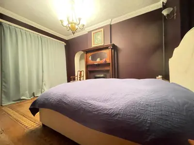 a bedroom with a large bed and a chandelier at THE RED dragon in Niagara Falls