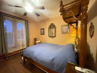 a bedroom with a bed and a ceiling fan at THE RED dragon in Niagara Falls