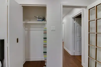 a hallway with white walls and a door to a closet at Beautiful House In Scarborough in Toronto