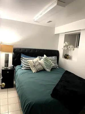 a bed with pillows on it in a room at Vintage 2 bed 2 bath suite Distillery District in Toronto