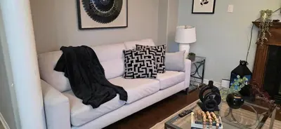 a white couch with pillows on it in a living room at short time rental in Kawartha Lakes