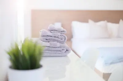 a pile of towels sitting on a table in a bedroom at Stay Inn Muskoka in Gravenhurst