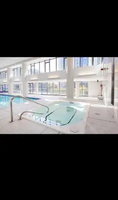 a large building with a swimming pool in a building at Spacious 2 Bedroom plus Den, 2 Bath, Sleeps 5 with Balcony and Lakeview Downtown Toronto Condo in Toronto