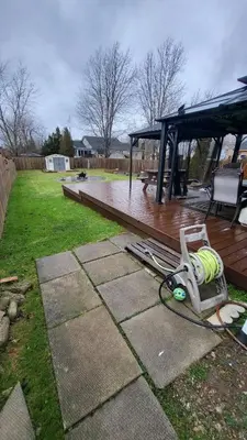 a backyard with a deck with a bench at Newly Furnished Modern Apartment in Welland