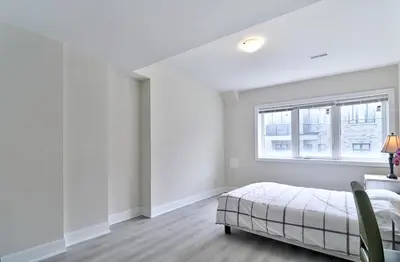 a white bedroom with a bed and a window at 50% discount Amazing 3 Bedrooms Guest Suite in Richmond Hill