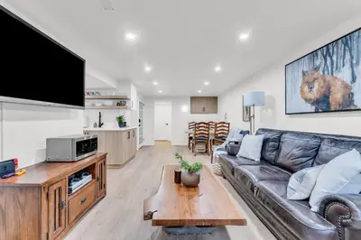a living room with a leather couch and a table at Bright 2-Bedroom Apartment in Burlington