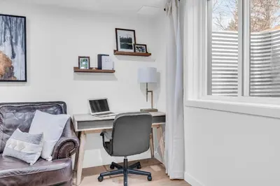 an office with a desk and a chair and a laptop at Bright 2-Bedroom Apartment in Burlington