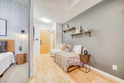 a living room with a couch and a bed at GSuite Express Downtown Toronto in Toronto