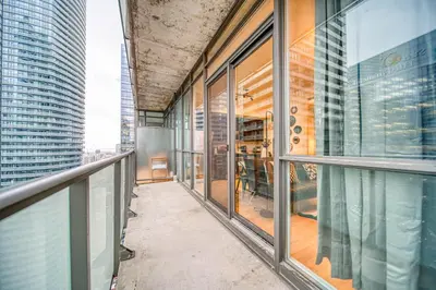 a balcony of a building with glass windows at GSuite Express Downtown Toronto in Toronto