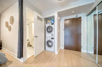 a laundry room with a washer and dryer at Stylish Downtown Toronto Suite with Free Parking in Toronto