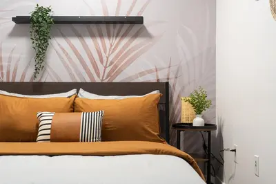 a bedroom with a bed with orange pillows at Stylish Downtown Toronto Suite with Free Parking in Toronto