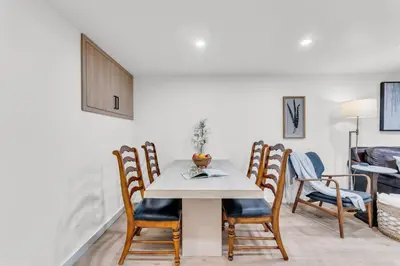 a dining room with a table and chairs at Spacious Elegance: Two Living Spaces in One Home in Burlington
