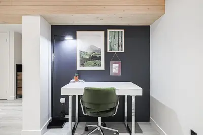 a office with a white desk and a green chair at Spa Oasis in Toronto's Heart-Free Parking! and Pet Friendly in Toronto