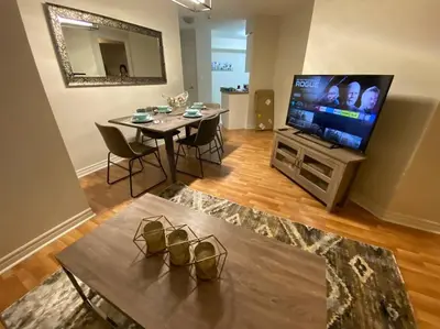 a living room with a table and a television at Alaa Aldahhan in Mississauga