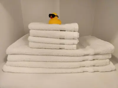a stack of towels with a rubber duck sitting on top at Queen St West Haven - Modern Loft, Downtown Toronto, Free Parking in Toronto